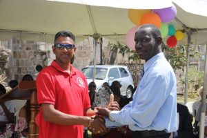 Mr. John Hanley, Acting Permanent Secretary in the Ministry of Tourism (left) presenting an award to Mr. Ganeshram Kistoo in recognition of his 15 years of service at the Nevisian Heritage Village in Gingerland at the 15th anniversary celebration on February 22, 2018