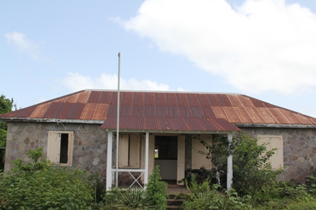 The dilapidated Cotton Ground Police Station next to the village play field now overgrown with bush  