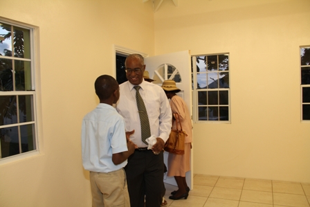 Premier of Nevis and Ministry responsible for Education on Nevis Hon. Joseph Parry interacts with a young resident of Barnes Ghaut moments after the Adult Education Centre was commissioned  