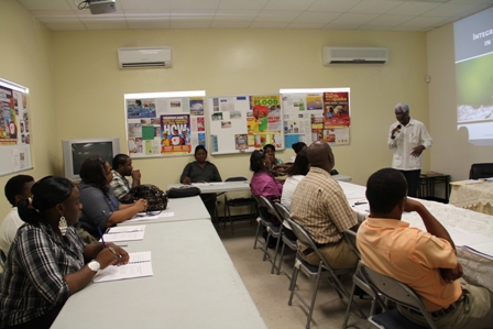 Participants listening intently to facilitator of the Integrated Vector Management Workshop Dr. Samuel C. Rawlins PhD at the Llewelyn Newton Disaster Management’s conference room at Long Point