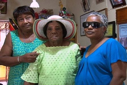 Birthday Girl Mrs Iris Pinney flanked by two of her daughters (L) Mrs. Icilma Browne and (R) Ms. Calmeta Pinney during her 95th birthday celebration at her home in Cox Village