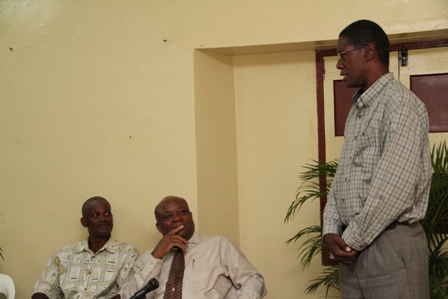 Basic Plumbing Installation Course participant Mr. Keithley Amory delivering the Vote of Thanks while (L-R) Course Tutor Mr. Alex Claxton and Social Development Minister Hon. Hensley Daniel listen attentively