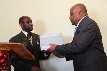 (L-R) Deputy Prime Minister and Federal Minister responsible for Social Security Hon. Sam Condor hands over medical equipment to Deputy Premier of Nevis and Minister of Health in the Nevis Island Administration Hon Hensley Daniel at the Alexandra Hospital’s conference room