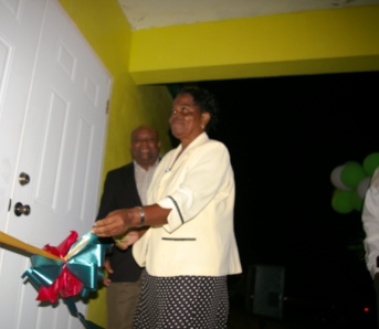 Miss Soretha France cutting the ribbon with Deputy Premier, Hon. Hensley Daniel looking on