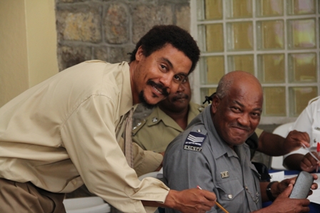 (L-R) Featured Speaker for the New Year’s Programme Mr. Noah G. Mills of SEN Consulting interacting with Police Officers in the Royal St. Christopher and Nevis Police Force Nevis Division  