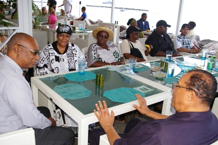 Hon. Joseph Parry and Minister Farrakhan chatting while his wife Mrs. Kadijah Farrakhan and family look on