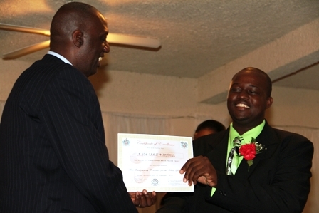 Constable of the Year in the Royal St. Kitts and Nevis Police Force Nevis Division Leon Michael (r) receives Certificate of Excellence from Royal St. Christopher and Nevis Police Force Commissioner Mr. Celvin G. Walwyn 