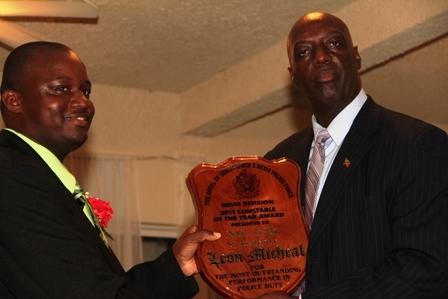 (L-R) Royal St. Christopher and Nevis Police Force Commissioner Mr. Celvin G. Walwyn present Constable of the Year Leon Michael with his award