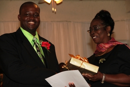 President of the Nevis Island Assembly Mrs. Christine Springette presents a Certificate of Performance to Constable of the Year in Nevis Leon Michae