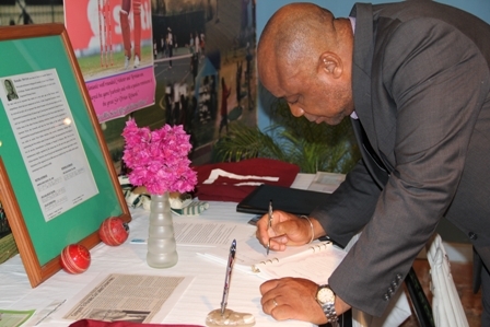 Deputy Premier and Minister of youth and Sports on Nevis Hon. Hensley Daniel signs the condolence book in memory of Runako Morton. His tribute reads: “Hensley Daniel – Gone too soon. May flights of Angels sing you to rest”