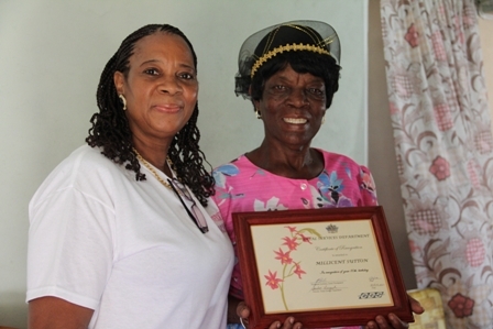 Director of Senior Citizens Division in the Department of Social Services Mrs. Garcia Hendrickson with 80 year old Birthday Girl Mrs. Millicent Sutton at her home in Cotton Ground