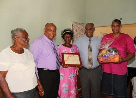 (L-R) Mrs. Millicent Sutton’s neighbour Merle, Deputy Premier and Minister of Social Development Hon. Hensley Daniel, birthday Girl Mrs. Millicent Sutton, Premier of Nevis Hon. Joseph Parry and caretaker Portia