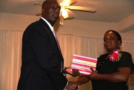 Third place out of nine nominees for the Constable of the year award Woman Police Constable Coretta Harris receives a gift from Police Commissioner Celvin G. Walwyn