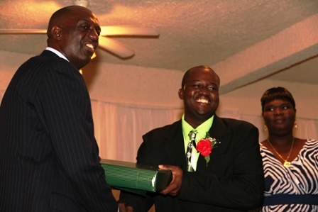 Top Constable for the Year Leon Michael receives a gift from Police Commissioner Celvin G. Walwyn