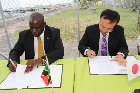 Minister of Agriculture and Fisheries in the Nevis Island Administration Hon. Robelto Hector (l) Chief Representative of Japan International Cooperative Agency (JAICA) Mr. Shoji Ozawa sign the grant agreement for the construction of the New Charlestown Community Fisheries Complex as witnesses. The agreement was signed moments before by Premier of Nevis and Minister of Finance Hon. Joseph Parry and Ambassador designate, Japan His Excellency Yoshimasa Tezuka