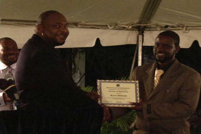 (L-R) Director of the Department of Information Mr. Huey Sargeant presents award to Mr. Kerry Williams at the Department of Human Resource’s Award Ceremony for Young Civil Servants, held at the Botanic Gardens. Permanent Secretary Mr. Chesley Manners looks on