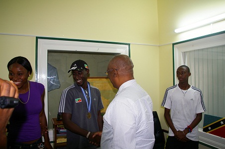 Premier, Hon. Joseph Parry congratulating Mr. Adrian Williams, gold medalist