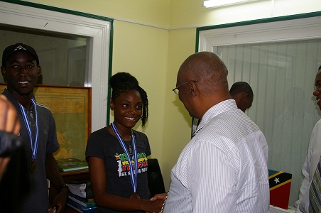 Premier of Nevis, Hon. Joseph Parry congratulating Miss Renika Daniel, bronze medalist