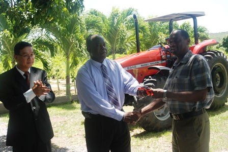 Minister of Agriculture in the Nevis Island Administration Hon. Robelto Hector (middle) hands over the keys of a new Massey Ferguson tractor, moments he received it from Republic of China/Taiwan’s resident Ambassador to the Federation His Excellency Ambassador Miguel Tsao, to Permanent Secretary in the Ministry of Agriculture Dr. Kelvin Daly at the Taiwan Mission in Cades Bay, Nevis while Ambassador Tsao looks on