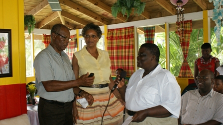 (L-R) The NevCan Cultural Association’s Vice President Mr. Hugh Jeffers along with the Organisation’s local representative Ms. Agnola Tyrell hands over cheque to Ms. Rodney Elliott for assistance with Grandson’s medical bills.