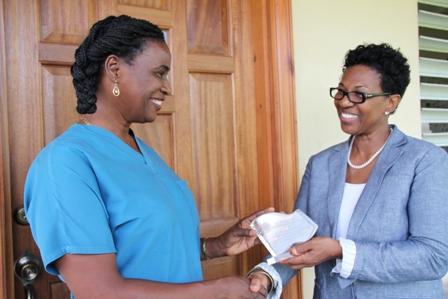 Permanent Secretary in the Premiers Ministry Mrs. Joslyn Liburd presents engraved plaque to the last of 17 honourees of the 29th Anniversary of Independence Awardees Dr. Patricia Bartlett at the Vet Services Department at Prospect