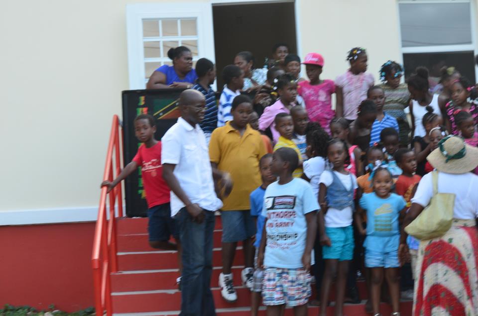 Attorney General, Hon. Patrice Nisbett and children enjoying the Christmas party in St. James Parish