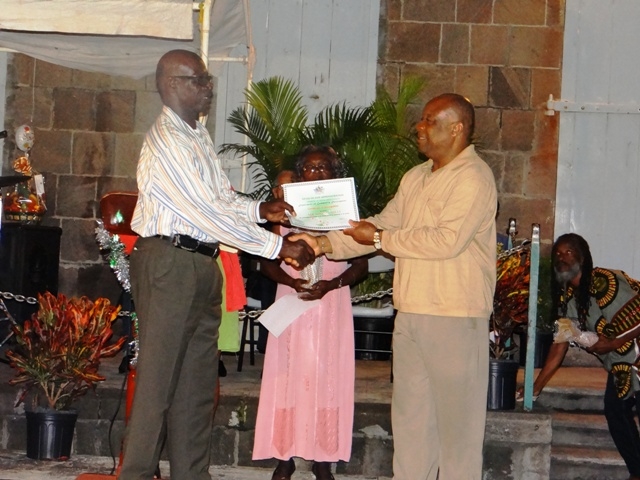 Advisor to the Premier of Nevis Mr. Hensley Daniel presents Certificate of Recognition from the Department of Community Development to honouree in the St. Georges Parish Mr. Miguel Mills