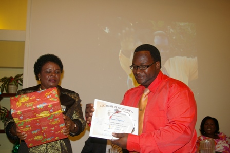 Mr. Reuel Sargeant a teacher at the Charlestown Primary School receives award from Mrs. Myrthlyn Parry, wife of the Premier of Nevis and Minister of Education at the 7th Annual Teacher Awards and Recognition Ceremony at the Mount Nevis Hotel on December 15th, 2012