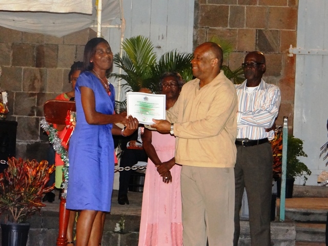 Advisor to the Premier of Nevis Mr. Hensley Daniel presents Certificate of Recognition from the Department of Community Development to honouree in the St. Thomas Parish Ms. Rubylette Thomas