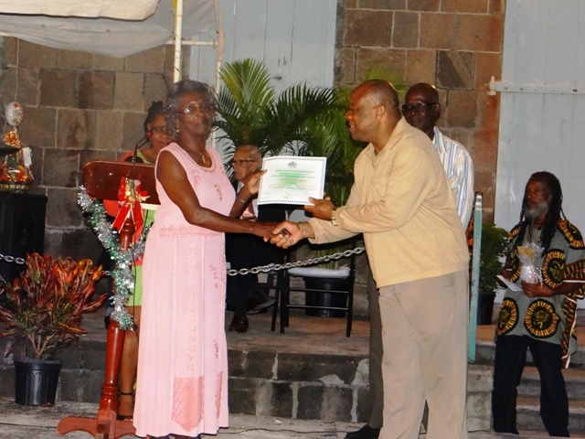 Advisor to the Premier of Nevis Mr. Hensley Daniel presents Certificate of Recognition from the Department of Community Development to honouree in the St. James parish Mrs. Eileen Weekes Walwyn