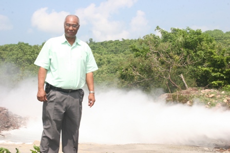 Hon. Joseph Parry during a visit to geothermal well in 2008 with proof of geothermal energy in the background at Spring Hill (file photo)