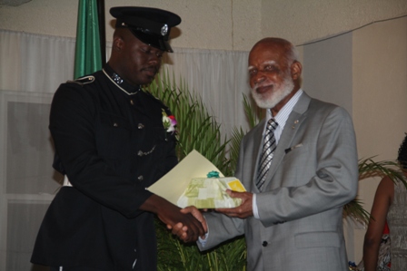 Second runner up for title of Constable of the Year in the Royal St. Christopher and Nevis Police Force Constable #750 Kishorn Charles of the Criminal Investigation Department receiving his recognition gift from Governor General of St. Kitts and Nevis His Excellency Edmund Lawrence