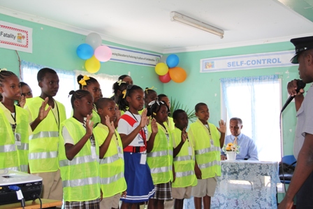 Violet O. Jeffers Nicholls Primary School’s School Safety Patrol supervisors and students being inducted by Constable Ronrick Huggins of the Royal St. Christopher and Nevis Police Force (New Castle Police Station) Liaison Officer for the VOJN Primary School