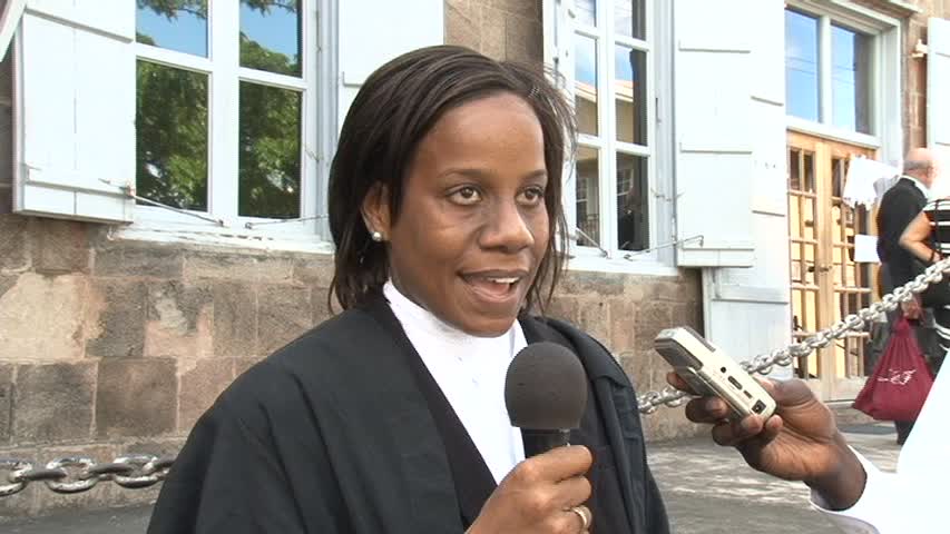 Nevisian Lawyer Ms. Fareeda Hobson with her parents Mr. and Mrs. Theodore Hobson in the backdrop outside the High Court in Charlestown