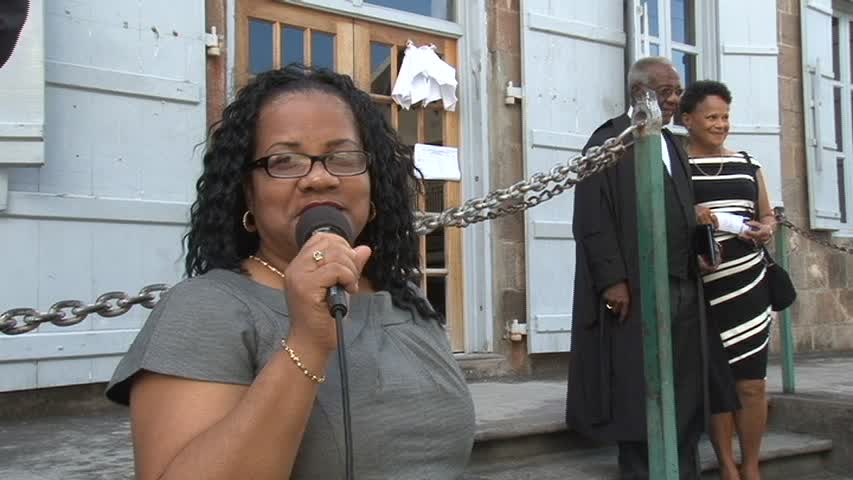 Mrs. Charmaine Hanley outside the High Court in Charlestown