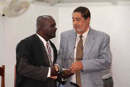 President of the Nevis Island Assembly, Honourable Farrell Smithen (left) receiving an awarded for his service and dedication to the Nevis House of Assembly from Deputy Governor General His. Honour Eustace John on December 10, 2013 at the Nevis Island Assembly Chambers, Hamilton House. Mr. Smithen first served the Assembly in the capacity of Clerk of the House