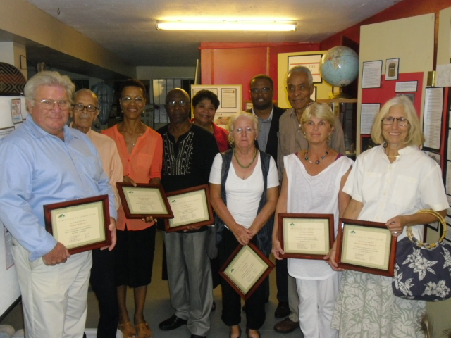 Photo caption: (L-R front) Awardees for long standing service to the Nevis Historical and Conservation Society Richard Lupinacci, Arthur Evelyn, Isabel Byron, Hanzel Manners, Jenny Lowery, Susan Gordon and Beverly Robinson. (Back row) Executive Director of the Nevis Historical and Conservation Society Evelyn Henville, Deputy Premier of Nevis and Minister of Culture Hon. Mark Brantley and Lloyd Hezekiah