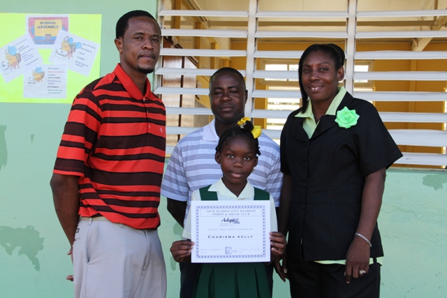 Ignacio Ottley Vice President the Four Seasons Five Diamond Sports and Social Club, Club President Lavorn Lawrence and Mrs. Janice Richards Principal of the Ivor Walters Primary School with the Four Seasons Five Diamond Sports and Social Club scholarship recipient Charisma Kelly