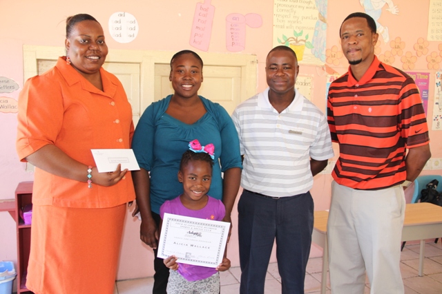 Principal of the St. James Primary School Ms. Daniele Wallace, Mrs. Sofia Wallace mother of the Four Seasons Five Diamond Sports and Social Club scholarship recipient Alicia Wallace, President of the Four Seasons Five Diamond Sports and Social Club Lavorn Lawrence and Vice President Ignacio Ottley