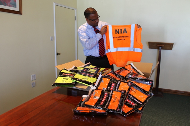 Hon. Mark Brantley displays one of 50 reflective vests he donated to the Ministry of Health on March 24, 2014 at the conference room of the Alexandra Hospital's Administration Building