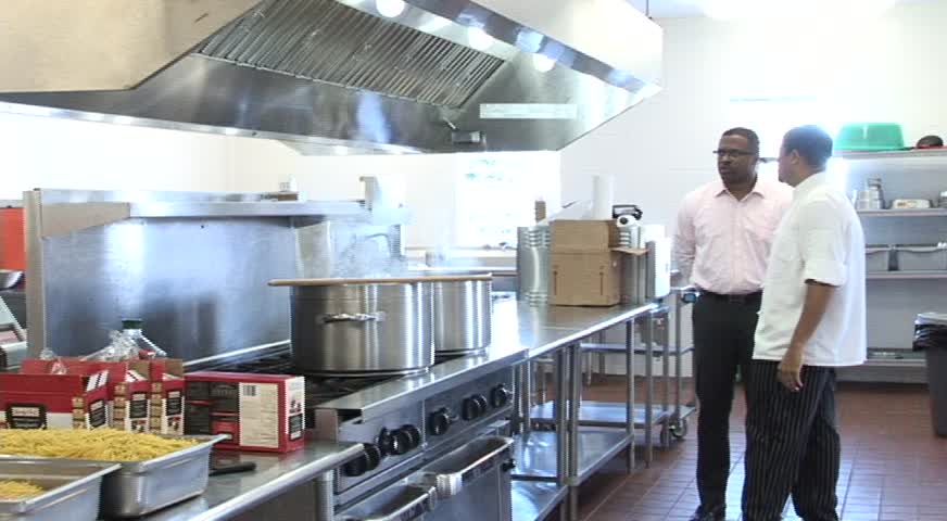 Master Chef Michael Henville leads Deputy Premier and Minister of Health Hon. Mark Brantley on a brief tour of the Charlestown Primary School’s cafeteria on March 03, 2014