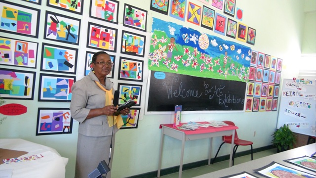 Elizabeth Pemberton Primary School Principal Marion Lescott stands before a section of drawings created by the students on display at an Art exhibition at the Elizabeth Pemberton Primary School on March 07, 2014