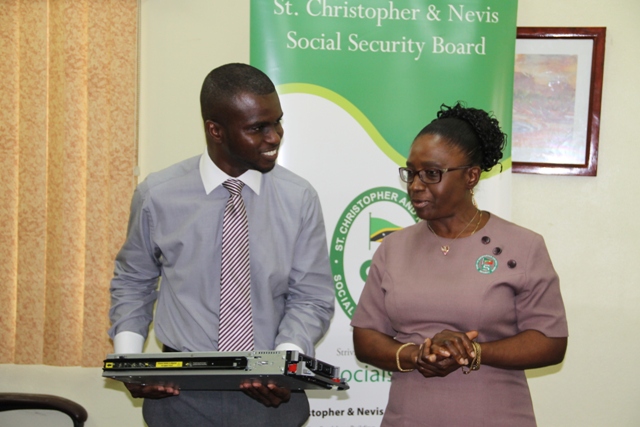 Head of the Information Technology Department in the Nevis Island Administration Quincy Prentice (L) with Director of the St. Christopher and Nevis Social Security Mrs. Sephlin Lawrence at the Ministry of Finance Conference room on May 22, 2014, during a handing over ceremony of server equipment for the Ministry of Finance from the Social Security Board