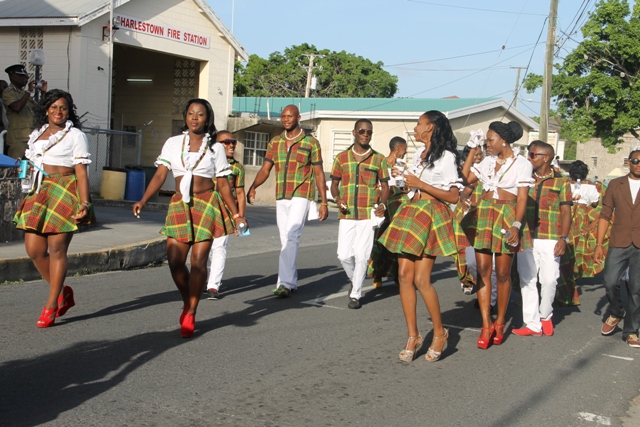 Participants for the Culturama 40 Miss Culture Swimwear and Mr. Kool contests dance through the streets of Charlestown moments before they were officially launched on June 13, 2014