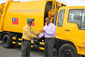Deputy Premier and Minister of Health in the Nevis Island Administration Hon. Mark Brantley(r), on July 23, 2014, hands over the keys to a waste disposal truck, a gift from the Government and People of the Republic of China (Taiwan) to Chairman of the Nevis Solid Waste Management Authority Board of Directors Carlisle Pemberton at Long Point