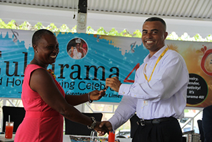 Ernie France, Managing Director of St. Kitts-Nevis-Anguilla Trading and Development Company (TDC Nevis Ltd.) officially handing over the keys to a red Toyota Yaris, valued at EC$80,000, to Culturama 40 Central Committee Chair Deborah Tyrell at a Culturama press briefing hosted at the Riviere House on Government Road on July 09, 2014. The car is a prize to be awarded to the winner of the 2014 Senior Kaiso Competition.