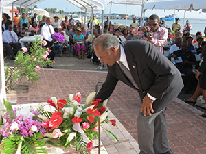 Premier of Nevis Hon. Vance Amory lays a wreath on behalf of the Nevis Island Administration at the Christena Disaster Memorial on the Charlestown Waterfront, during a memorial service to mark the 44th anniversary of the tragic event which claimed 233 lives
