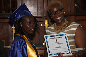 Charlestown Secondary School’s Caribbean Certificate of Secondary Level Competence (CCSLC) Valedictorian Ochanta Parris receives her Certificate of Graduation from Mrs. Marva Roberts