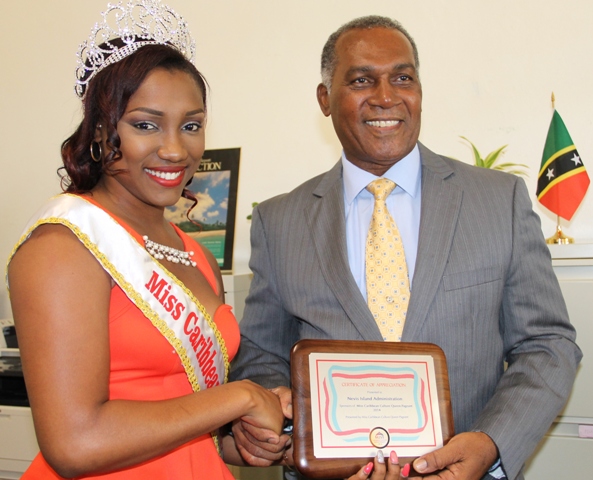 Reigning Miss Caribbean Culture Queen Yarani Morton presenting a token of appreciation to Premier of Nevis Hon. Vance Amory at his Bath Hotel office on January 15, 2015