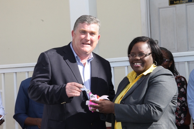 Junior Minister responsible for Social Development Hon. Hazel Brandy-Williams receiving the keys to a new mini bus from Insurance Manager for AMS Trustees Derrick Lloyd for use in the Sports Health and Wellness programme